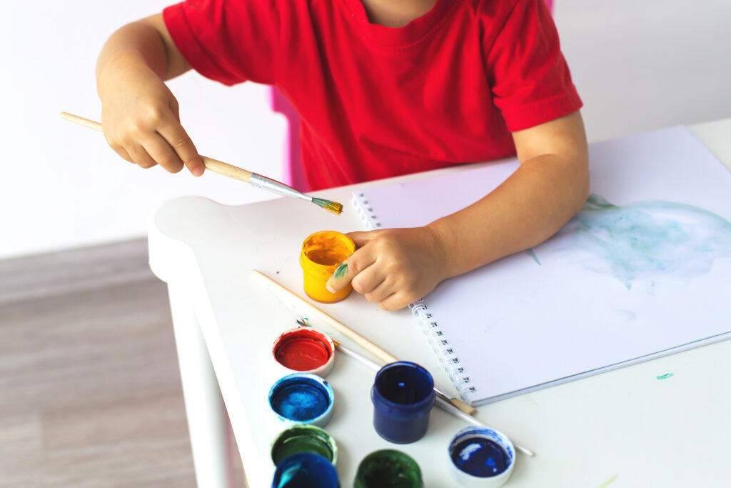 Child painting in a classroom art session